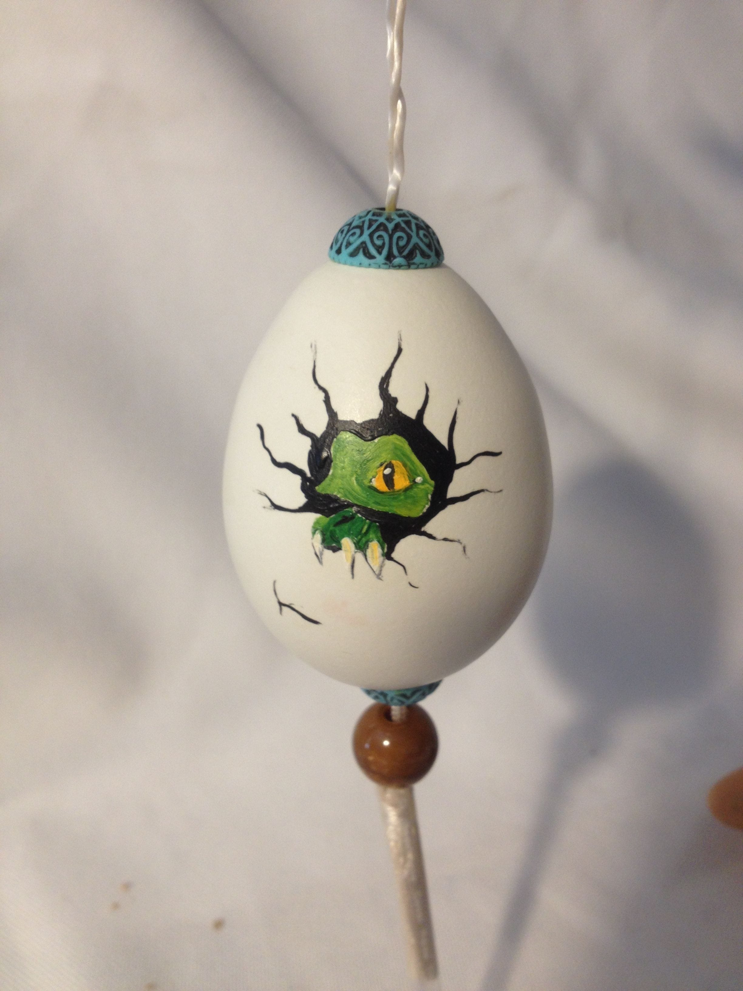 Painted chicken egg with green dragonett's face$20.