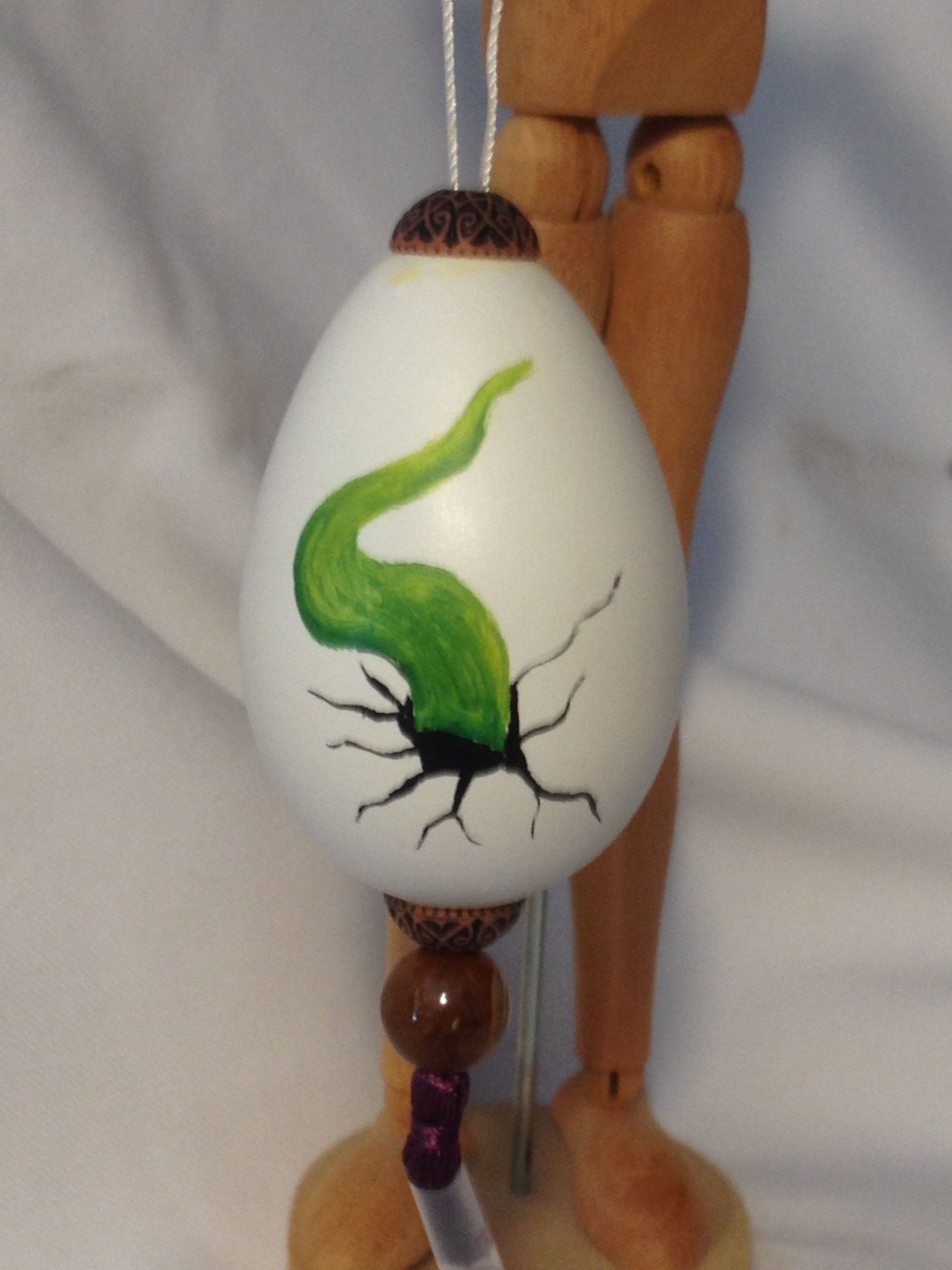 Oil paint of hatching green dragonett tail on chicken egg $20.