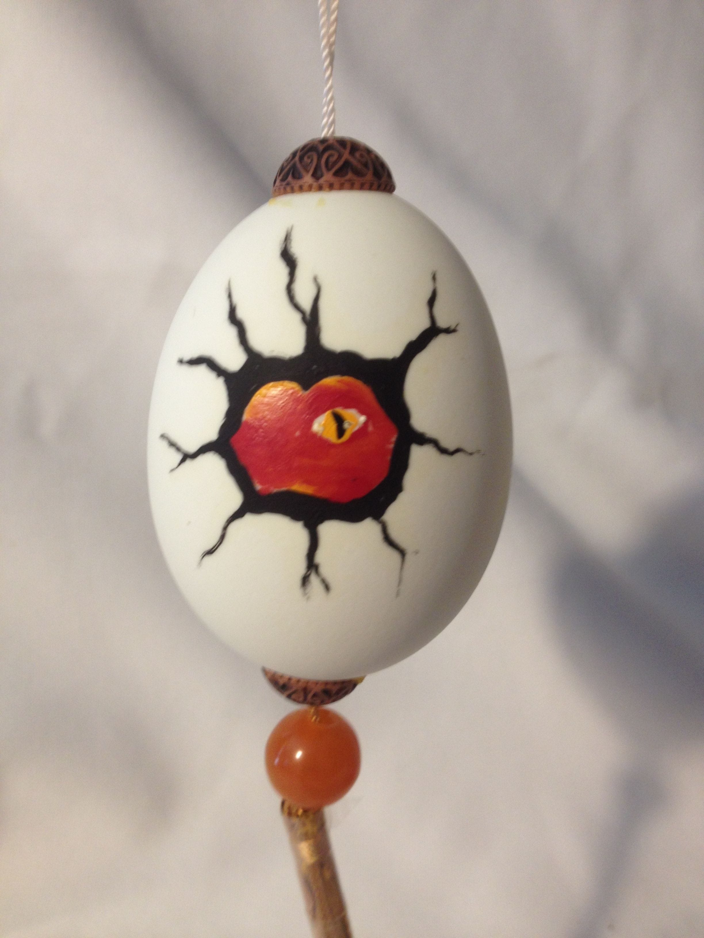 Painted chicken  egg with red dragonett face $20.